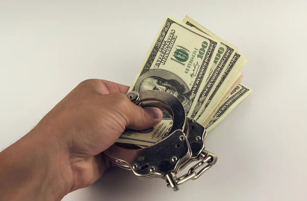 Suborno, mão dando dólares com algemas — Fotografia de Stock