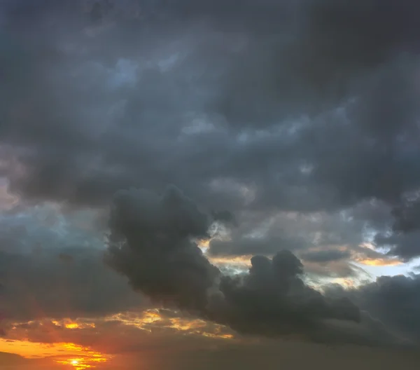 Sunset in stormy gray clouds — Stock Photo, Image