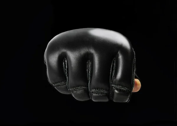 Fist black  gloves for martial arts , mma on a black background. — Stock Photo, Image