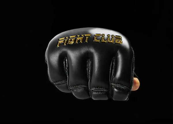 Svart hanske for kampsport, med gyllen innskrift "fight – stockfoto
