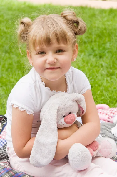Little girl playing with her favorite soft toy — Stock Photo, Image