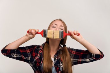 bir boya fırçası tutan genç kız