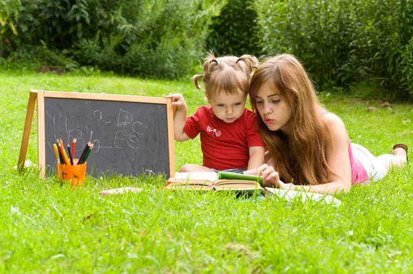 Mother teaches her young children letters — Stock Photo, Image