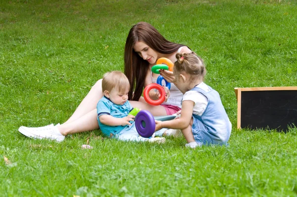 Mother teaches her young children letters — Stock Photo, Image