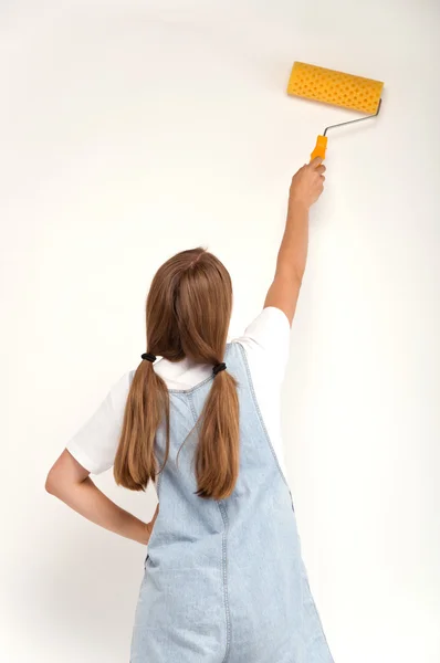 Young girl holding a paint roller Stock Image
