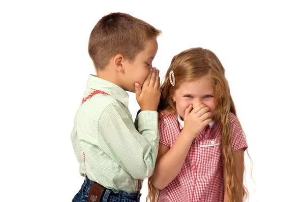 Menino contando um segredo para uma menina . — Fotografia de Stock