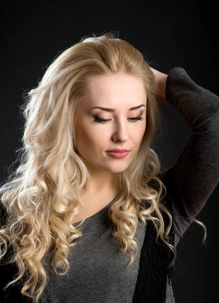 Successful beautiful girl with blond curly hair — Stockfoto