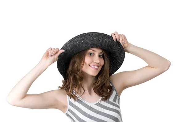 Flickan ler och håller händerna en hatt — Stockfoto