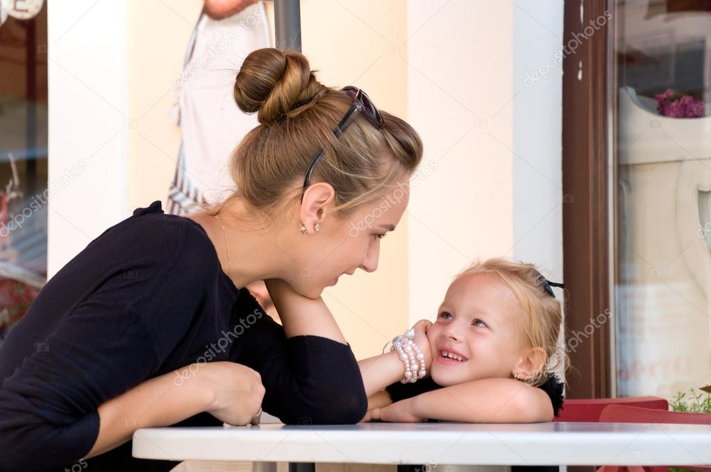 mother and daughter spend time in cafes