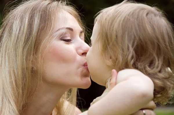 Maminka dává dcera kiss — Stock fotografie