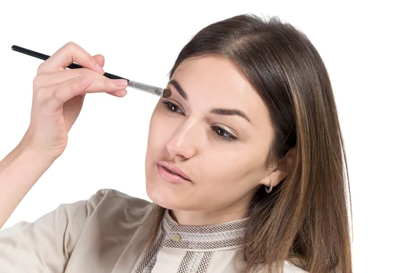 Young girl paints her eyes. Girl doing makeup — Stock Photo, Image