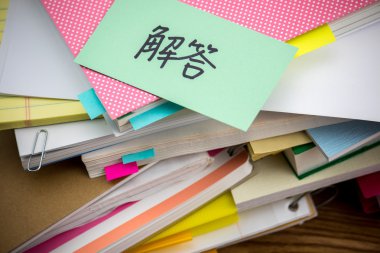 Cevap; Masanın üzerindeki iş belgeler yığını