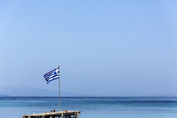 Греческий флаг на фоне синего моря и неба — стоковое фото