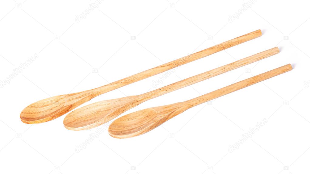 three spoons of different sizes made of natural wood on a white isolated background