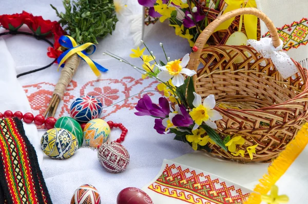 Easter holiday. Easter eggs with flowers on the Ukrainian towel and basket