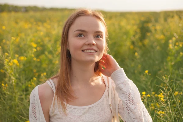 Woman with open arms in the green rapeseed field at the morning. — Stock Photo, Image