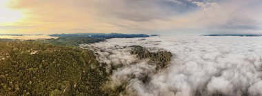 Aerial panoramatic morning view of rocks and Ketepu peak with clouds in the valley in the North Kalimantan (Borneo), Indonesia