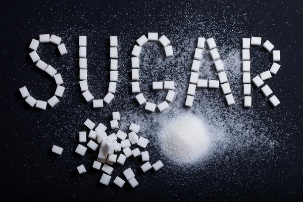 Cukru napis napisany kawałek cukru — Zdjęcie stockowe