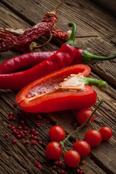 Red hot chili peppers, sweet pepper on wooden table — Stock Photo, Image