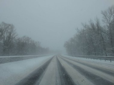 Kar fırtınasında araba kullanmak. Sürücü camından, kar ve buzla kaplı yola kadar görüş mesafesi zayıf. Kışın aşırı hava. Kış, Tipi.