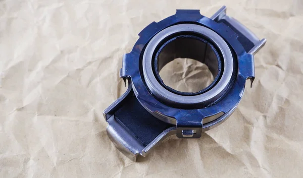 Car spare parts. Release bearing of a car on a background of craft paper