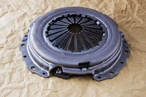 Passenger car clutch basket. Photo of a new clutch on a background of craft paper.