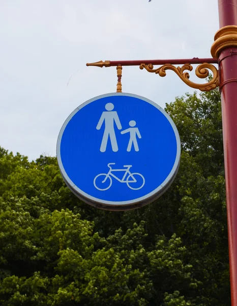 Road sign on the post. Walking and cycling area. Bicycle and pedestrian lane road sign on pole post, blue