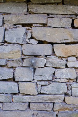 Kum taşı mason dokusu. Kum taşlarıyla kaplı bir duvar. Doğal taş arkaplan.