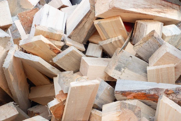 Waste from wood production. Firewood. sawn wood cut piled perfectly as backround. Waste wood timber background