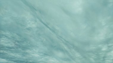 Yumuşak, bulanık bulut desenli soyut turkuaz gökyüzü arkaplanı. Tasarım, sunum ve yaratıcı projeler için minimalist atmosfer dokusu ideali.