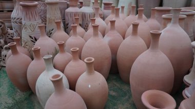 Rows of terracotta pots with narrow necks displayed