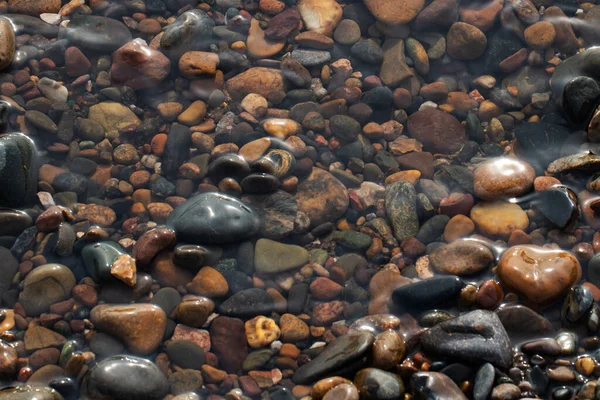 Beautiful river stones in the water. Eco-friendly water. Environmental protection. Clean beach.