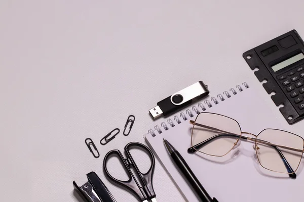 A blank sheet of notepad for your congratulatory message. Close-up, top view, white background. No people. The concept of preparing for the holiday. Office, office supplies. The office. Flat lay.