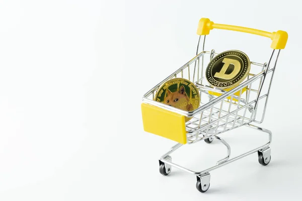 Bir alışveriş arabasında kripto para birimi dogecoin beyaz bir arka planda yakın plan