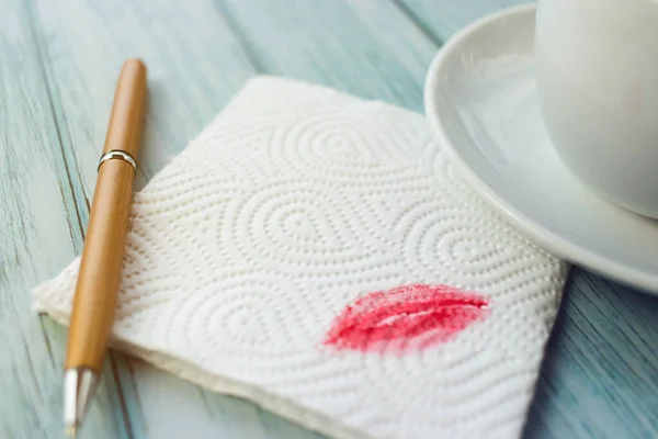 Napkin with a kiss on a wooden light table in a cafe in a close-up