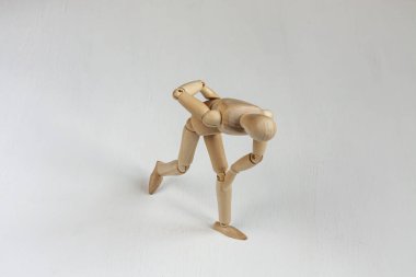 Sırt ağrısı çeken eğri büğrü bir tahta manken.