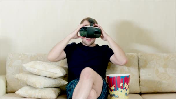 Man using VR glasses sitting on the sofa — Stock Video