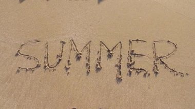 Kum plajı üzerinde kelime yaz