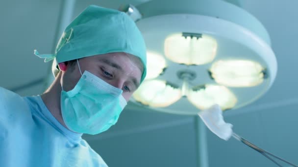 Витираючи піт від чола хірургів — стокове відео