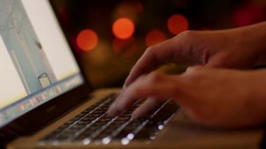 Working in Laptop by Christmas Tree