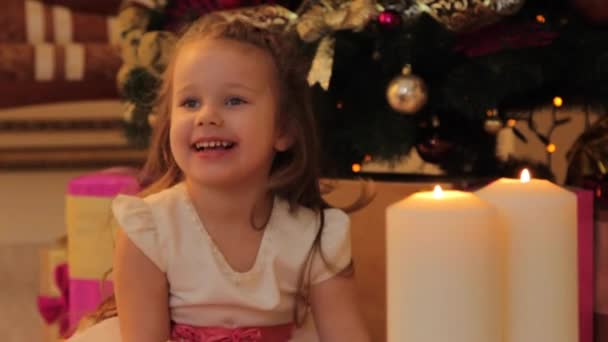 Girl Sitting by the Christmas Tree with Present Box — Stock Video