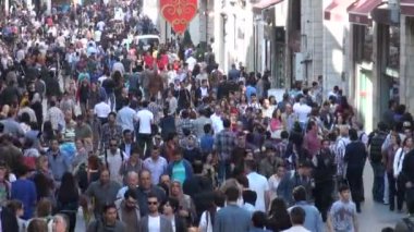 İnsanlar alışveriş caddesi boyunca yürürler.