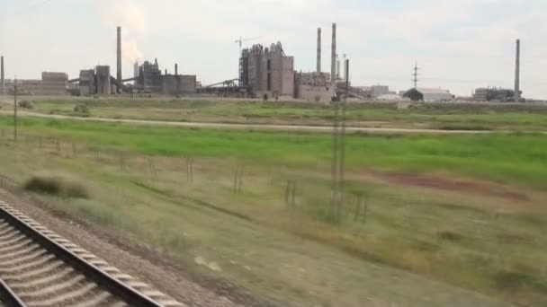 Riding a train past Soviet factories — Stock Video