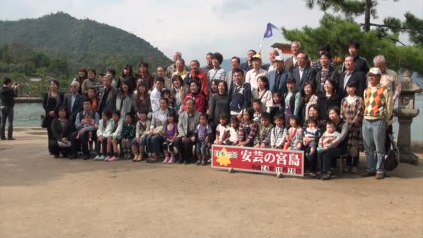 La gente toma fotos frente a la isla de Miyajima . — Vídeo de stock