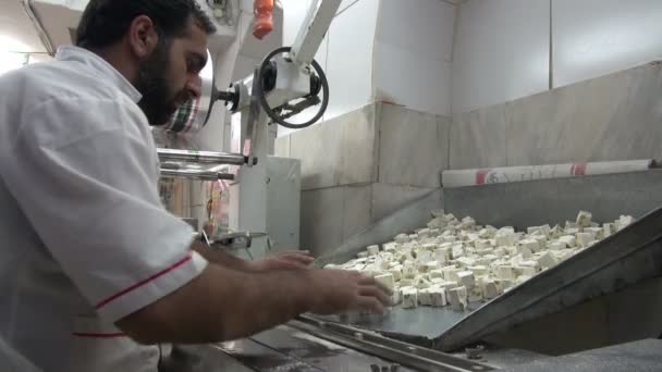 Man sorts pieces of nougat — Stock Video
