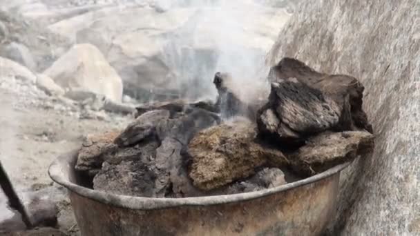 Burning manure in front of a yurt. — Stock Video