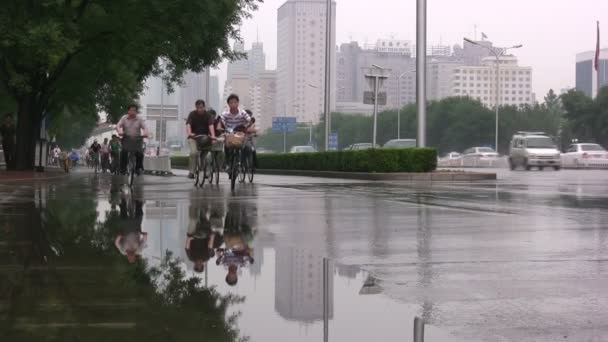 Lidé cyklus deštěm v Pekingu. — Stock video