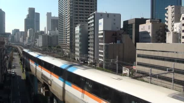 Monorail riding through urban landscape — Stock Video