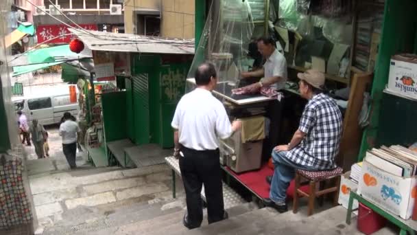 En man är strykning skjortor på gatan — Stockvideo