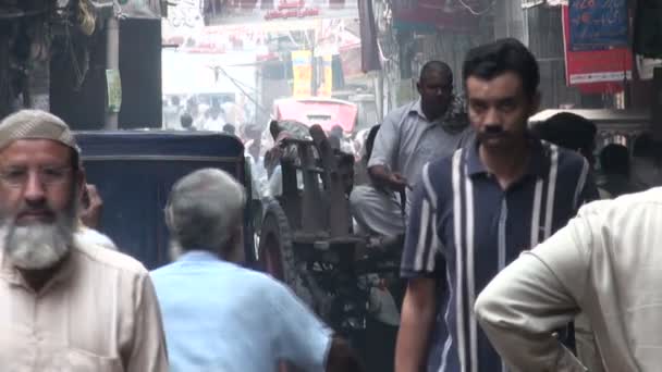 As pessoas caminham por uma rua em Lahore — Vídeo de Stock